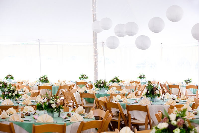 A look inside a tent set for fine dining during a wedding or oth