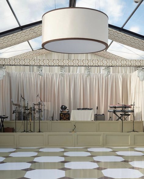 Custom checkerboard pattern dance floor beneath a round drum pendant light
