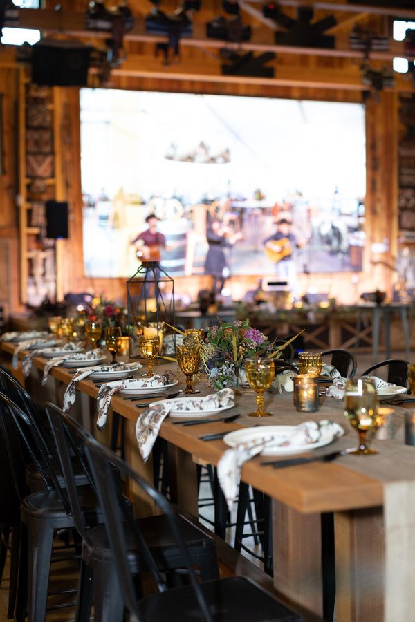 Live band performing on stage behind a long table setting