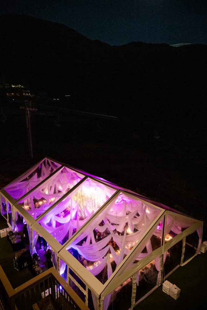 Tent interior lit with purple uplighting at night
